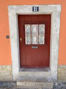 decorative red door in a building in Portugal