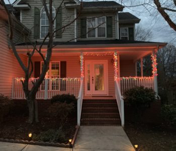 front porch of house with Christmas light