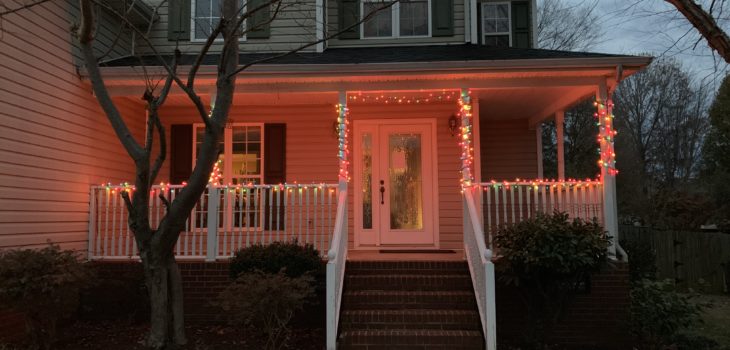 front porch of house with Christmas light