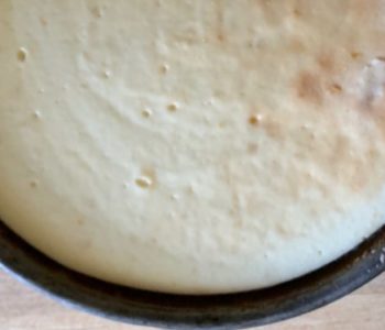 Baked cheesecake in a springform pan resembles a full moon