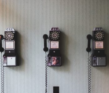 phrases-to-give-up picture of three rotary phones on a wall