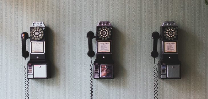 phrases-to-give-up picture of three rotary phones on a wall